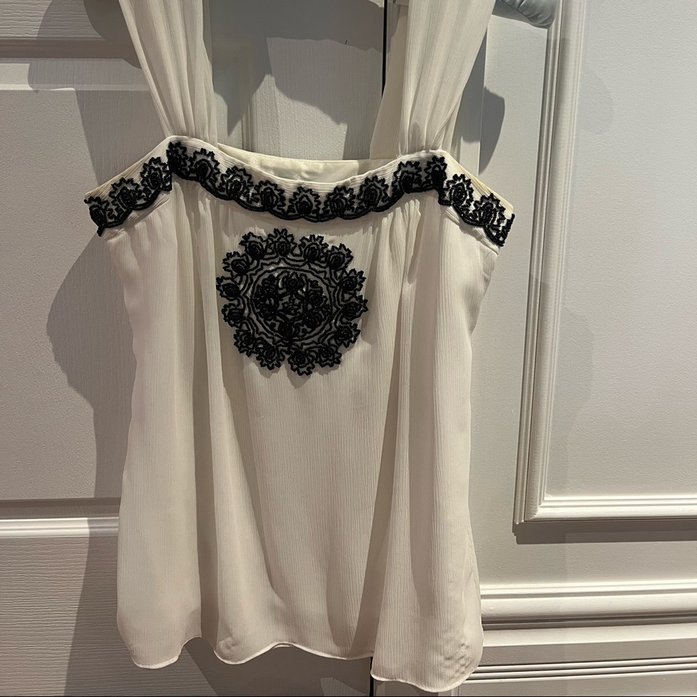 Flowy sheer white blouse with black beadings medallion